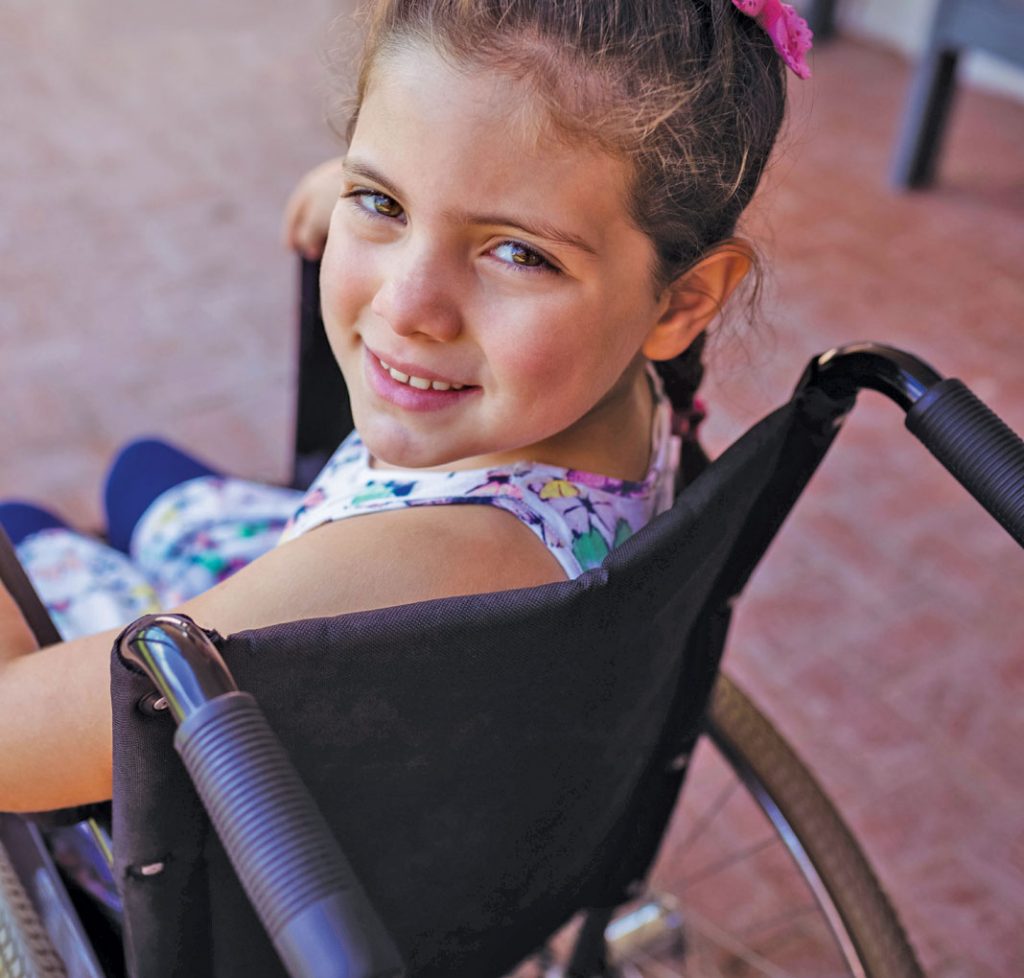 Girl in a wheelchair looking over her left shoulder | Careers in occupational therapy