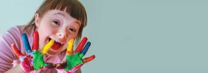 girl with finger paint on her hands | speech and language therapy