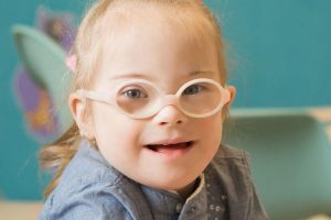 Little Girl with down syndrome wearing pink Glasses | Physical Therapy