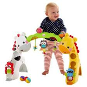 Infant standing up between stuffed animals